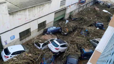 Getty Images The force of the floods caused cars to crash into each other on a street in Picanya