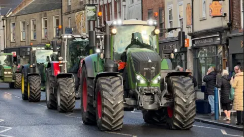 A convoy of tractors through Morpeth's high street.