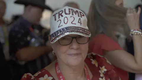 Woman wearing sparkly Trump cap