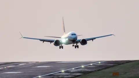 A plane lands on the runway at Leeds Bradford Airport