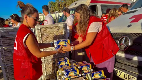 EPA/Shutterstock Red Cross personnel prepare food donations for migrants in Ceuta, Spain, 03 August 2026. 