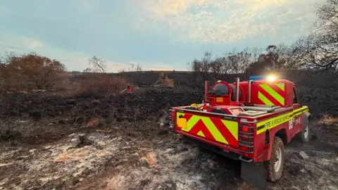 An off-road fire vehicle in a scorched area of the New Forest