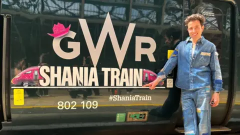 GWR Image of Nick Grimshaw next to a green GWR train with Shania Train branding