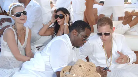 Getty Images Paris Hilton, Kim Kardashian and Sean "Diddy" Combs are photographed astatine  a 2006 White Party event. 