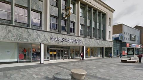The Marks and Spencer building in Sunderland city centre with a Sports Direct next to it and passers-by