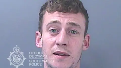 South Wales Police Custody photo of Steven Chappell with short hair and a patchy beard 