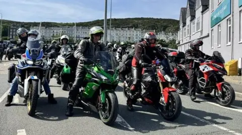 A group of motorcyclists driving out of Douglas ferry prot.