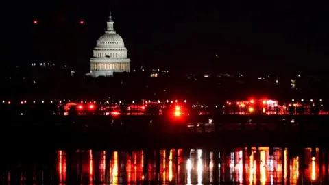 Reuters Emergency services at work on the Potomac River with the US Capitol building behind