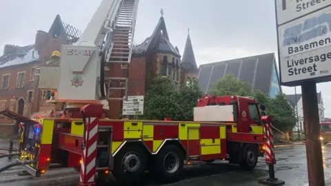 Derbyshire Fire and Rescue Service Fire engine at smoking building