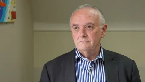 Chris Bown in front of a white background