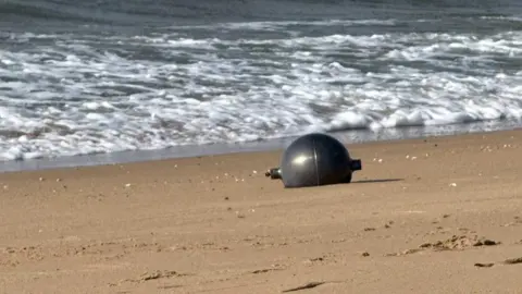 One of the six mysterious large silver spheres washed up on Forrest Beach in Queensland.