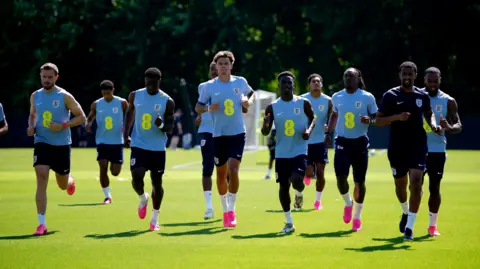 PA Media The England squad go for a jog during training ahead of their tournament opener against Croatia on Wednesday.