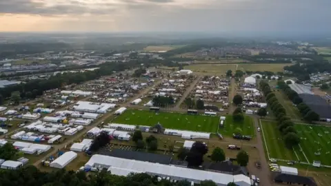 Royal Norfolk Show An aerial photograph looking down at the Norfolk Showground. Dozens of large white tents are visible.
