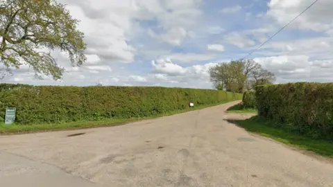 Google A Google Maps street view image shows a country road lined by hedgerows