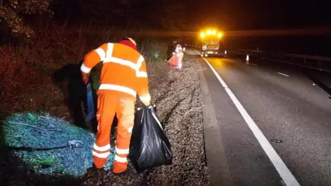 Colchester City Council A man cleaning up the side of the road wearing a high-vis jacket. He is carrying a black bin bag 