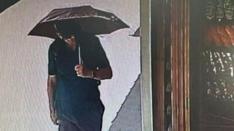 CCTV footage appears to shows Michael Mosley in the main street of Pedi holding an umbrella