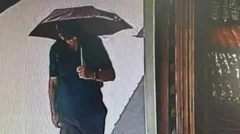 Live News / Mega TV CCTV footage appears to shows Michael Mosley in the main street of Pedi holding an umbrella