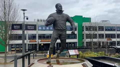 The bronze Billy Boston statue in Believe Square in Wigan.