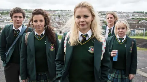 Channel 4 Promotional shot of the cast of Derry Girls, featuring the five main characters all wearing a green school uniform