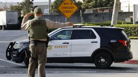 A police officer directing traffic outside the Biscailuz Center Academy Training centre