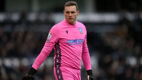 David Stockdale in a pink Sheffield Wednesday kit during the Sky Bet League One between Derby County and Sheffield Wednesday at Pride Park Stadium on December 03, 2022 in Derby, England