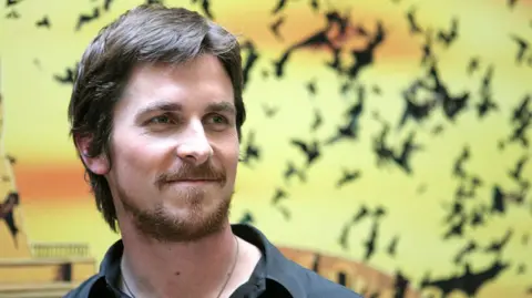 Christian Bale stood against a backdrop of bats during a "Batman Begins" Rome Photocall in Rome.