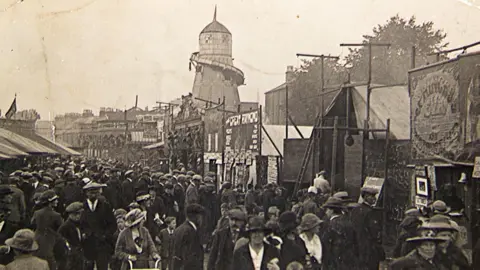 Fair Scotland A black and white picture of a fairground in Dumfries with hundreds of people milling around