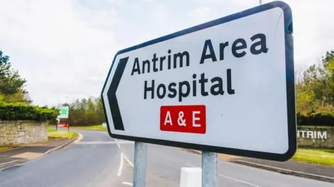 Getty Images Sign at an entrance on a road pointing to Antrim Area Hospital's A&E