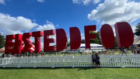 Harry, 7, and Freddie, 5, outside the National Eisteddfod sign in Pontypridd