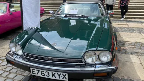 A green Cabriolet Jaguar XJS