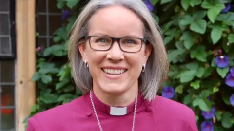 Diocese of Chichester A portrait photograph of Bishop Ruth Bushyager, Bishop of Horsham, wearing her purple cassock.