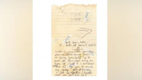Gloucestershire Police A piece of old yellowy-coloured lined paper which has been ripped out of a notebook. The paper has two dark hairs on it which have been circled. The note starts in the middle of the page and appears to read: 'Wish I was with you now. Please come back soon or bring yourself up to end of road and bring me home at 1' o clock I am tired cold and missing you to much. My darling, got £70 now. Lets be together I hardly ever see you.'