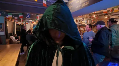 Siobhan Farmer, manager at The Rising Sun in Colden Common, wearing the green traitor style cloak