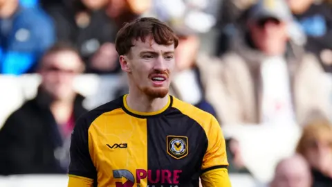 Michael Spellman in amber and black playing for Newport County