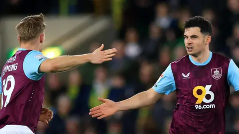 John Egan goes to high-five a Burnley team-mate