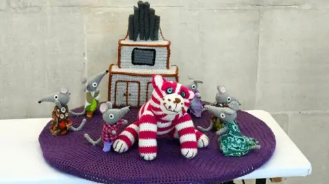 Andy Newbold A postbox topper of a cat with mice