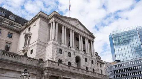 Getty Images The Bank of England on a cloudy summer day with the City buildings in the background