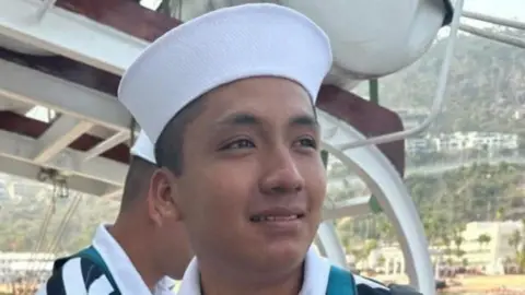 Facebook An undated photo shows a smiling Adal Jair Maldonado Marcos in a stripy top and a cao aboard a ship.