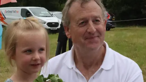 Ian Haynes Co-organiser Nicholas Dickinson with child winner