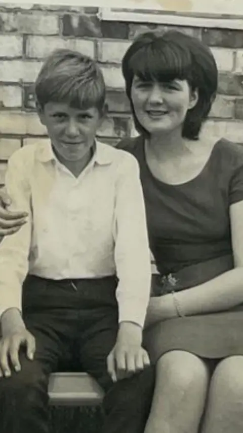 Halina Grabiec Halina Grabiec with a 60's bob hairstyle sat next to another teenager at the park. 