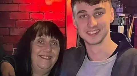 Family handout Jay Slater with his arm around his mother 