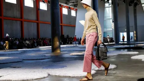 Reuters A model wearing Prada walks on the runway at the Milan Fashion Week in June.