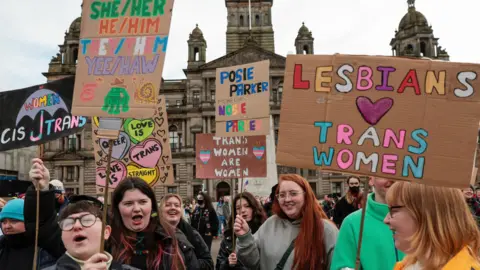 Getty Images Pro trans rights protestors hold placards in Glasgow's George Square 