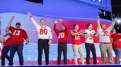 EPA members of the Mankato West American Football team on stage at the Democratic National Convention