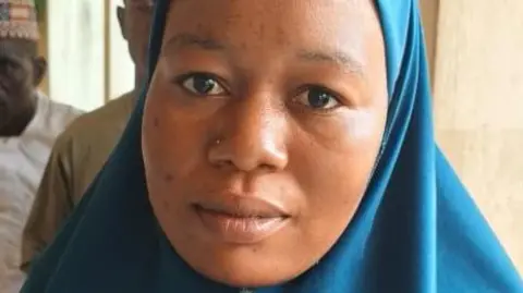 Mahmud Bashir One of the Nigeria mass wedding brides Amina Alhassan wearing a blue Hijab