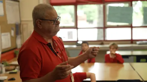 A man talks to the class