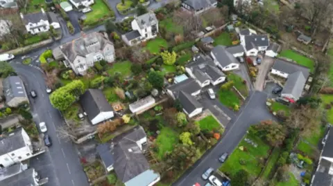 An aerial view of the village of Silverdale with its houses and green gardens.