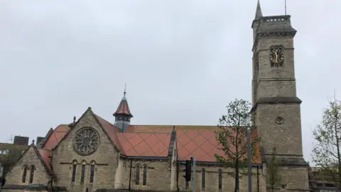 LDRS A wide view of the former Christ Church in Hartlepool with the 120 ft high clock tower on the right. A large circular window can be seen on the left side of the building.