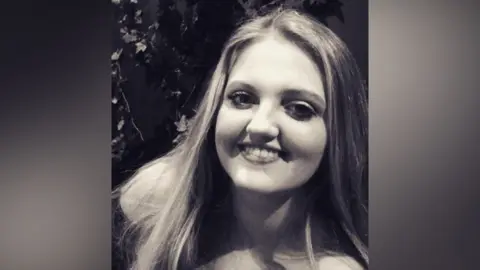 Family handout A black and white picture of a young woman with long blonde hair smiling at the camera.