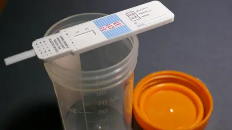 Getty Images A drug test on top of an empty urine sample bottle